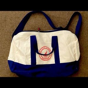 Carry on tan bag with blue handles and strap